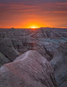 The sun is setting over the badlands of the badlands